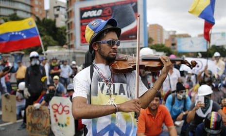Wuilly Arteaga plays his violin before clashes with government forces at a march against Venezuela’s president Nicolas Maduro in Caracas in May.