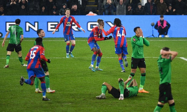 Crystal Palace's Jairo Riedewald celebrates scoring his side's second goal with Wilfried Zaha while Stoke players look dejected