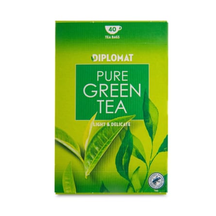 A green box of Diplomat teabags features leaf imagery and reads “Pure Green Tea”