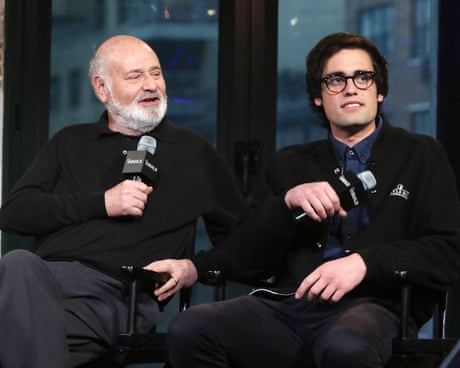 two men sitting next to each other and holding microphones