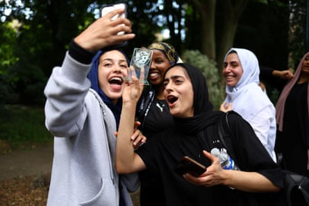 Fatima Ali, 26, and Sara Taleghani, 25, video-call Yasmin Abdullahi, 30, the founder of Sisterhood FC, to celebrate their first match win, at The Colombo Centre, in June