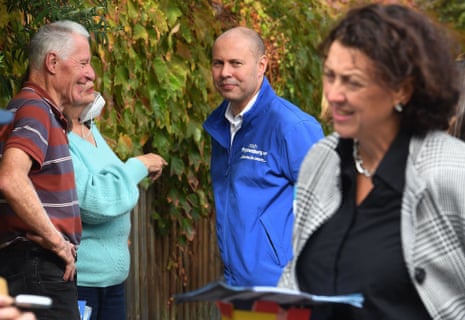 Josh Frydenberg speaks with voters in his electorate of Kooyong as as he looks at independent candidate Monique Ryan