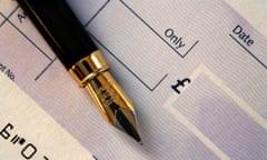 Fountain Pen on a Cheque Book. Banks charge nearly £3.8bn in excess charges, amounting to £152 per customer per year.