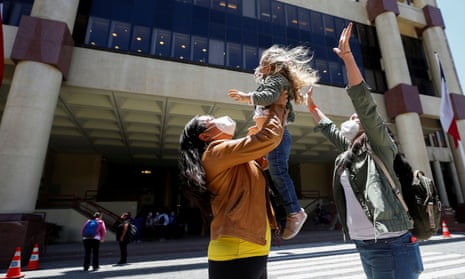 A couple reacts with their daughter outside the congress as the senate votes to approve a same-sex marriage bill in Valparaíso, Chile, on 7 December.  