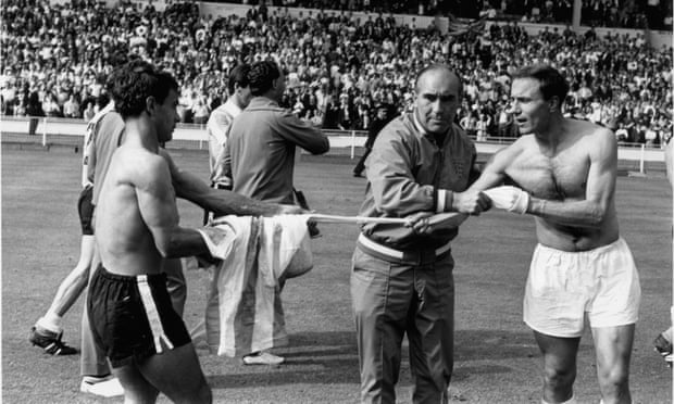 England manager Alf Ramsey prevents George Cohen from swapping his shirt with an Argentina player after the bad tempered World Cup quarter-final at Wembley which England won 1-0.