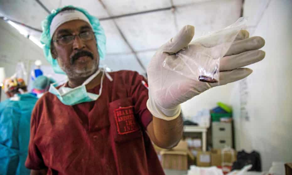 An anaesthetist from the International Committee of the Red Cross displays a bullet at a clinic in Old Fangak, Jonglei state, South Sudan