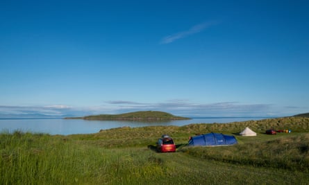 car and tents overlooking sea