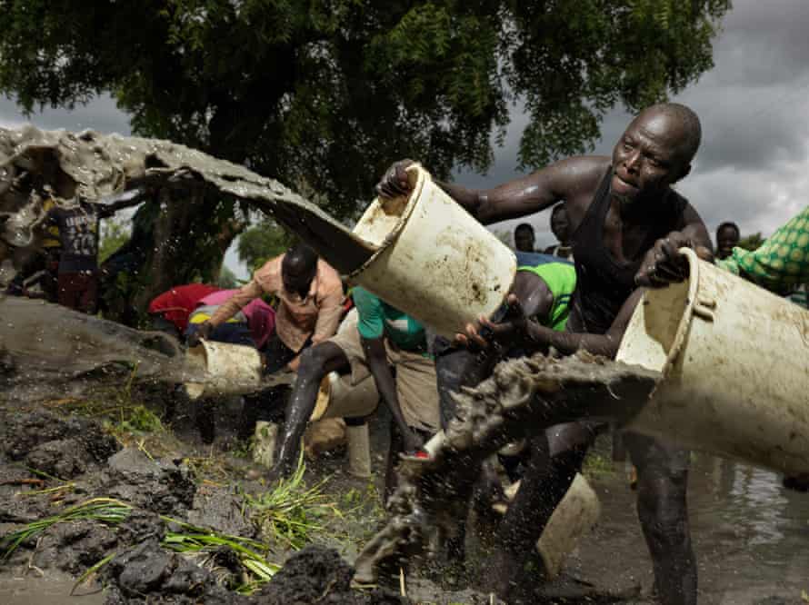 James Ruach scoops flood water