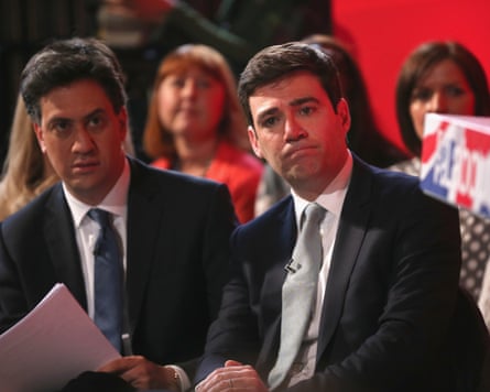 Andy Burnham and Ed Miliband in 2015 sitting side by side in a hall, with Miliband clutching papers.