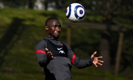 Naby Keita in training, wearing a grey training kit, in the act of heading or controlling the ball