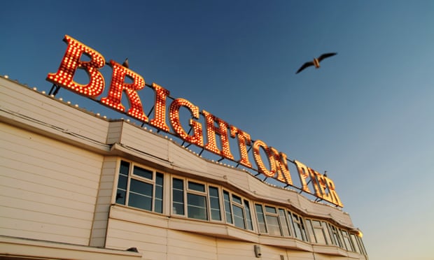Brighton Pier with seagull flying over.