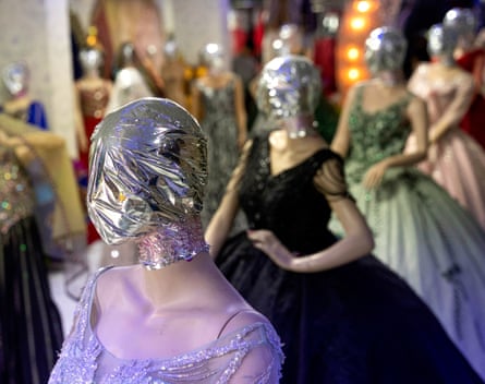 Veiled mannequins dressed in elaborate dresses are pictured at a shop in Kabul on 25 July 2024.