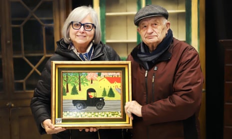 Irene and Tony Demas with the Maud Lewis painting which they acquired from one of their regular customers in exchange for lunch at their restaurant in London, Ontario, in the 1970s.