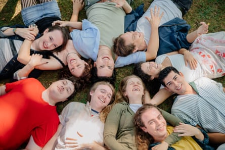 a group of people laying in grass
