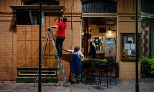 General Manager of Pere Antoine Restaurant Gaige Rodriguez, left, and cook Michael Dillon board up windows as they prepare for the arrival of tropical storm Zeta in New Orleans.