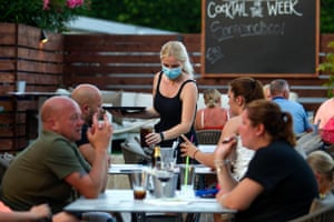 A waitress serves tourists at a restaurant in Palmanova on the island of Mallorca on Monday.