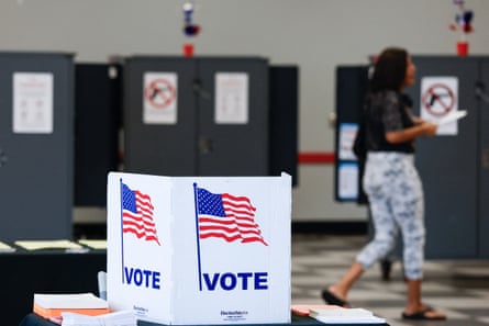 A person walking with ballot in hand at polling site
