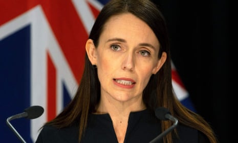 Head and shoulders of Ardern looking serious as she answers a question at a press conference