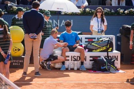 Carlos Alcaraz gets medical attention for his wrist during a match against Otto Viratanen at the Barcelona Open
