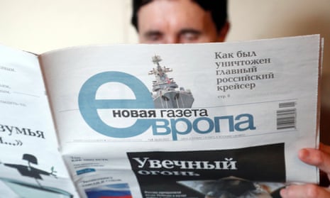A woman reads a copy of Novaya Gazeta's European version