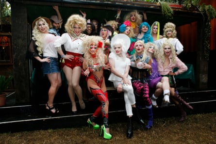 A large group of drag queens pose for a photo