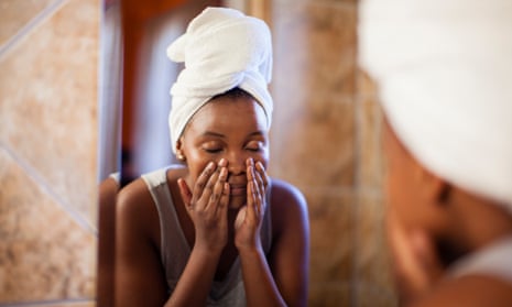 Woman moisturising her face