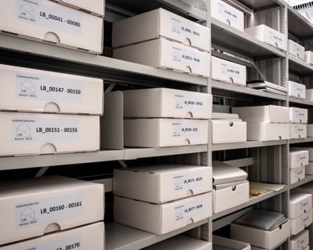 Stacks of white boxes on shelves