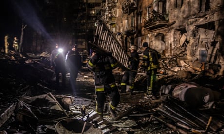 Rescuers moving concrete blocks at the site of a maternity ward destroyed by shelling in Vilniansk, Zaporizhzhia region.