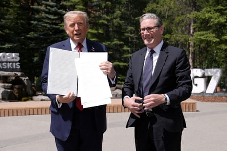 Donald Trump holding the US-UK trade agreement he finalised with Keir Starmer.