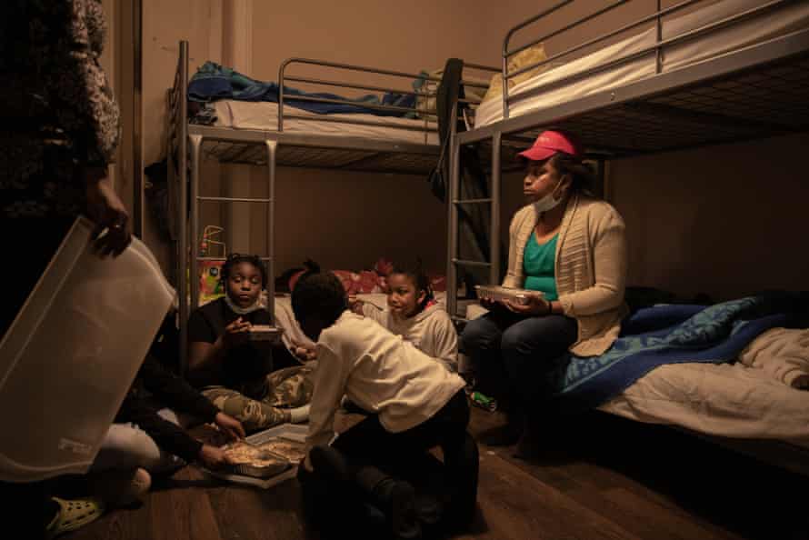 Dulce (left) and her niece give the children their dinner.