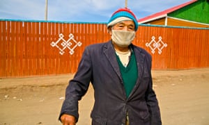 A Mongolian man wears a air-pollution mask