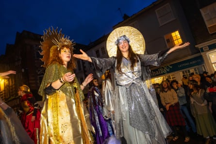 Stilt walkers welcome the winter solstice.