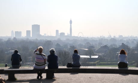People enjoy a day out at Primrose Hill as a high air pollution warning was issued for London on 24 March 2022. Photo by Justic Tallis/AFP via Getty Images