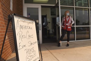 American Red Cross volunteer Faith Reihing stands outside a pop-up shelter for evacuees from the Cameron Peak wildfire at Cache la Poudre Middle School in Laporte, Colorado, on 7 September 2020. More than half a million people have been forced to flee their homes as destructive wildfires sweep across the western US, and experts say that could lead to historic numbers of people turning to shelters in the region, all in the middle of the coronavirus pandemic.