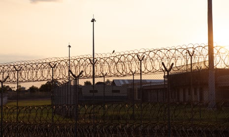 barbed wire of a detention centre at sunset