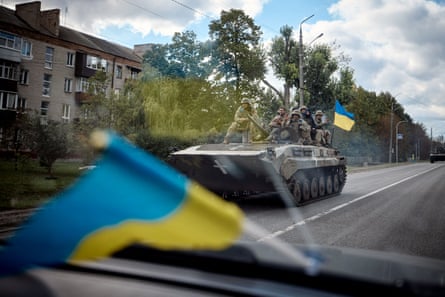 Ukrainian soldiers on a tank in a street of Kupiansk