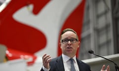 Qantas CEO Alan Joyce standing in front of a Qantas plane.