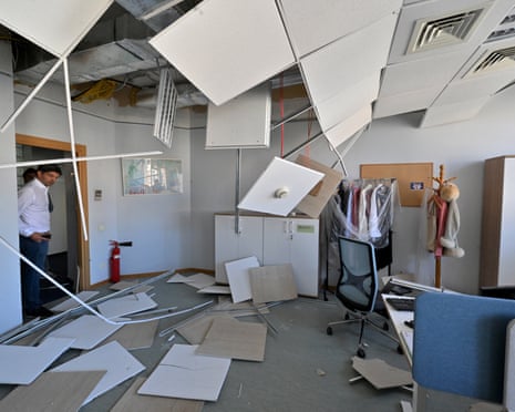 A EU employee watch damages in the offices of the European Union delegation in Ukraine after a Russian missile and drone attack on apartment blocks that killed at least 14 people in Kyiv in August last year.