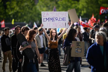 A protester holds a placard reading ‘The youth screws the FN/RN’ as thousands of people protest against far-right Rassemblement National in Rennes last week.