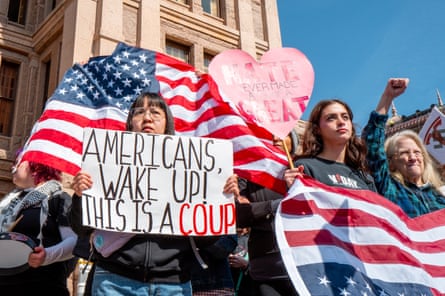 People with signs and US flags