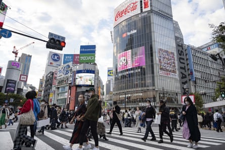 Locals and tourists cross at Tokyo’s world famous Shibuya crossing 