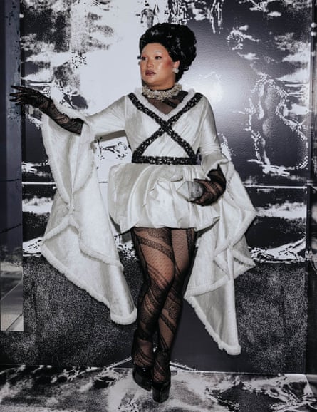 Aysha Buffet wears a bubble hem silver gown with calf-length angel sleeves.