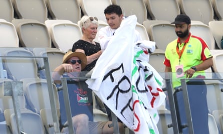 Security remove a banner on day four of the first Test match between Australia and Pakistan at Optus Stadium in Perth