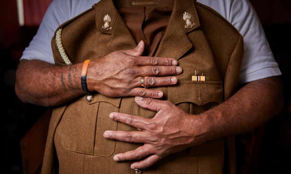 Fijian-born soldier holding uniform