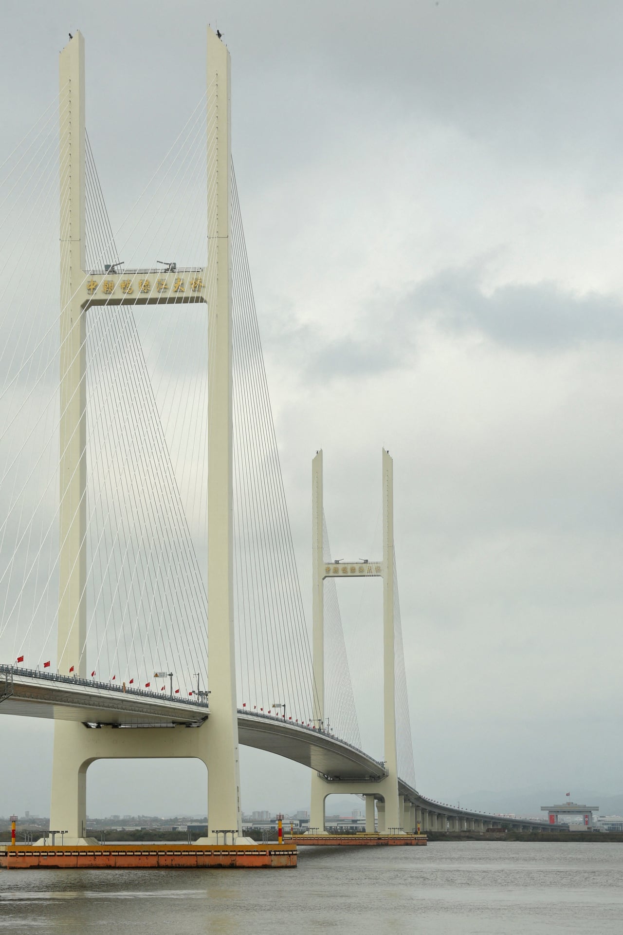 The New Yalu River Bridge’s cable-stayed towers span the river linking China and North Korea