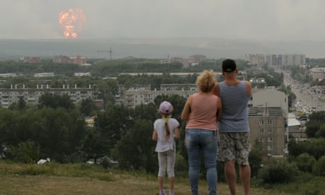 People watch flame and smoke rising from the site of blasts at an ammunition depot in Krasnoyarsk region<br>People watch flame and smoke rising from the site of blasts at an ammunition depot near the town of Achinsk in Krasnoyarsk region, Russia August 5, 2019. REUTERS/Dmitry Dub NO RESALES. NO ARCHIVES