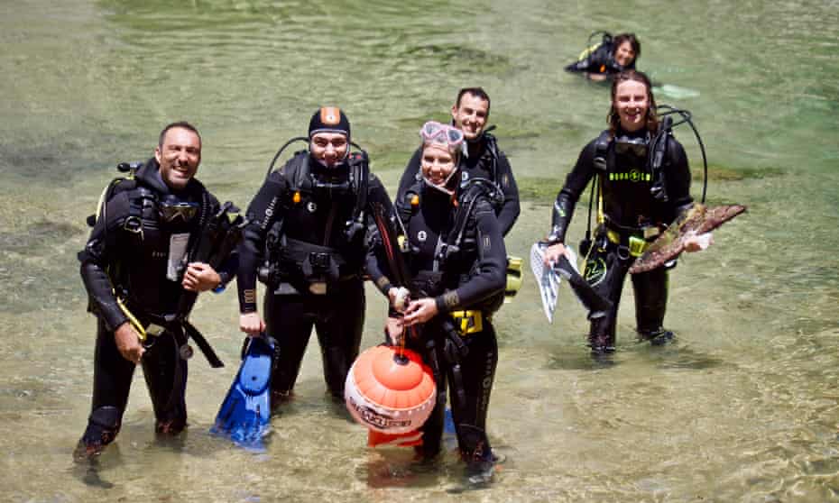 Divers coming out of the water with gear in Portugal