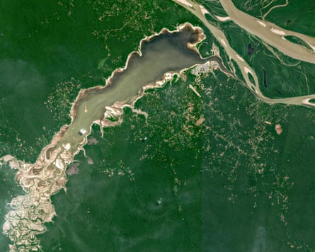 A satellite image of a lake amid a green expanse, showing water retreating at one end