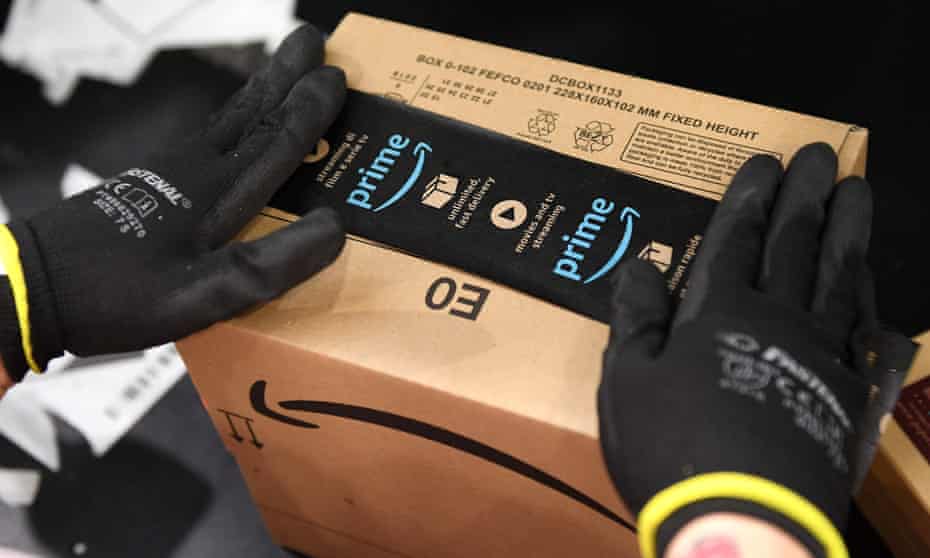 An Amazon worker packs an item at the fulfilment centre in Peterborough