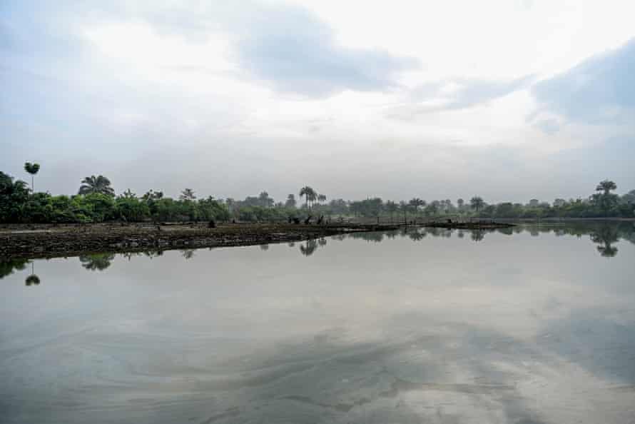 Oil sheen is seen on top of the water in a creek